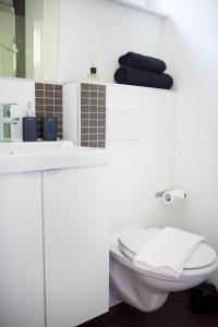 a white bathroom with a toilet and a sink at KELLER APARTMENT l 10E in Sulz am Neckar