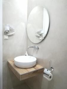 a bathroom with a white sink and a mirror at Loginos Studios in Kallithea Halkidikis