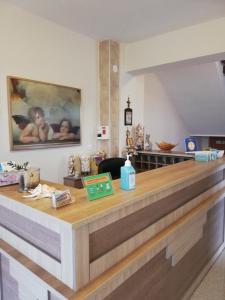 a reception counter in a room with a painting on the wall at Denis Studios and Apartments in Paralia Katerinis