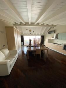 a living room with a white couch and a table at Molino Apartments in Desenzano del Garda