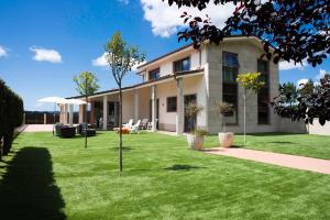 a house with a green lawn in front of it at Chalet Vilanova in Cee