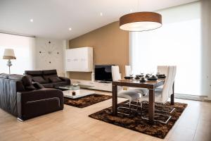 a living room with a table and a couch at Chalet Vilanova in Cee