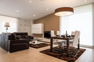 a living room with a couch and a table at Chalet Vilanova in Cee
