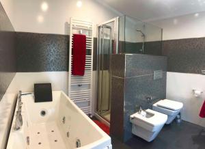a bathroom with a tub and a sink and a toilet at Chalet Vilanova in Cee +37 photos