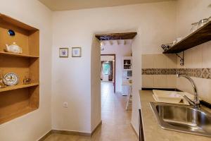 a kitchen with a sink and a counter top at Kristina´s Apartments in Rhodes Town