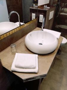 a bathroom with a sink with towels on a counter at Wein Ferienhaus Kerner in Lieser