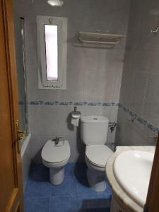 a bathroom with a toilet and a sink at COSTA DE ALMERIA PLAYA in Almería +12 photos