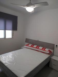 a bedroom with a bed with red pillows on it at COSTA DE ALMERIA PLAYA in Almería