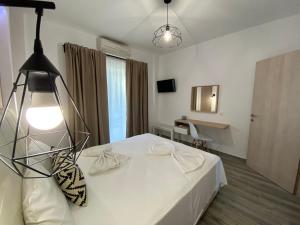 Postel nebo postele na pokoji v ubytování Christina Apartments