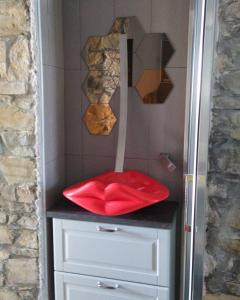 a shower with a red seat on top of a dresser at KISS from CILENTO in Celso