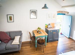 a living room with a couch and a table at Widewath Barn in Penrith