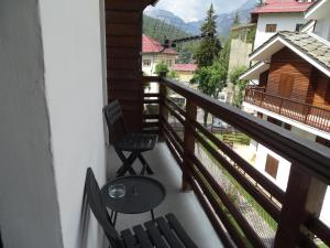 a balcony with two chairs and a table at Pensione Bianca in Bardonecchia