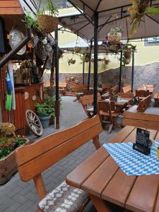 a patio with wooden benches and tables in a restaurant at Zirbe - Bayerischer Hof in Rüdesheim am Rhein