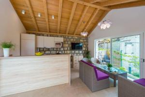 a kitchen with a dining table and purple chairs at Villa Sarah in Lopud Island