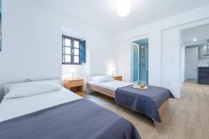 a hotel room with two beds and a kitchen at Villa Sarah in Lopud Island +29 photos