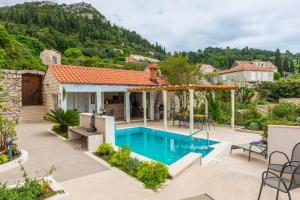 a house with a swimming pool in a yard at Villa Sarah in Lopud Island