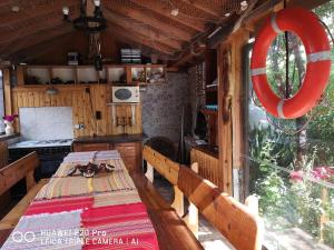 a kitchen with a table and a red life preserver at Guest House "Zora - Sarafovo" in Burgas