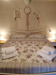 a bed with two pillows and a night stand at B&B Paradiso in Gubbio