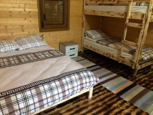 a room with two bunk beds in a cabin at Ethno House Bektesevic in Gusinje