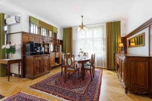 a dining room with a table and a kitchen at Villa Meri in Pärnu