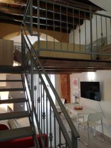 a staircase leading up to a loft with a table at LA CASETTA DI MARTA ai Quattro Canti di Giusi in Palermo