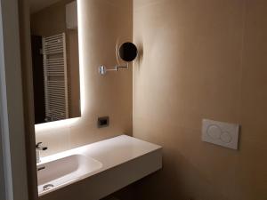 a bathroom with a white sink and a mirror at Hotel Aquarius Venice - Ascend Collection in Venice