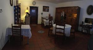 a dining room with tables and chairs and a room with a fireplace at B&B Aarsabroch in Bruges