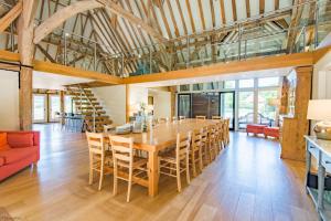 a dining room with a large wooden table and chairs at Great Higham Barn Complex by Bloom Stays in Canterbury