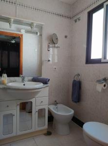 a bathroom with a sink and a toilet and a mirror at MAEVA PLAYA BUNGALOW in El Campello +79 photos
