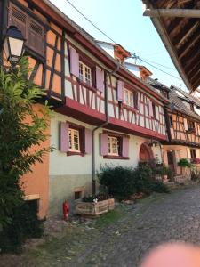 a building with a red fire hydrant in front of it at Les Terrasses du Donon in Raon-lès-Leau +28 photos