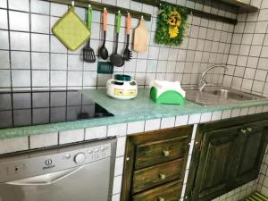 a kitchen with a sink and a counter with utensils at Montedarena GOLD in Pulsano