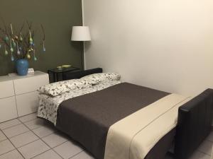 a bedroom with a bed and a table with a lamp at 3per3 in Busto Arsizio