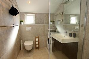 a bathroom with a toilet and a sink and a shower at Apartman Gajka in Supetar