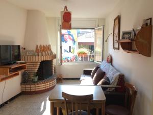 a living room with a couch and a fireplace at Casa Taller Penelles in Penellas