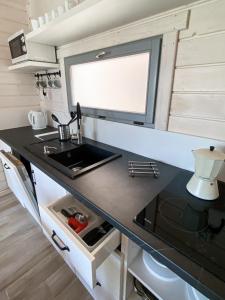 a kitchen with a sink and a counter top at LABALAND in Gąski