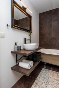 a bathroom with a sink and a bath tub at Modern spacious studio w/ Sea Views in Klaipėda