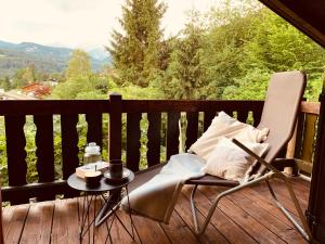 a chair and a table on a deck with a view at Mountainhome Birringer in Marktschellenberg