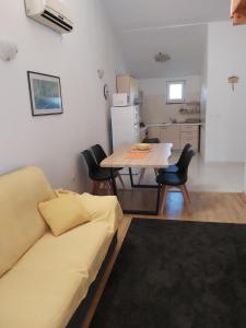 a living room with a couch and a table at Apartment Niko in Vir +47 photos