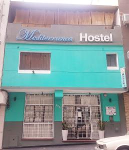 a blue building with a hospital sign on it at Hostel & Spa Mediterránea in Córdoba