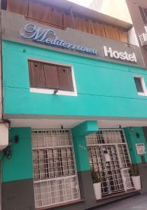 a blue building with a medical emergency hospital at Hostel & Spa Mediterránea in Córdoba