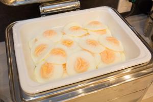 a white bowl filled with sliced bananas on a counter at Kuretake Inn Nagoya Hisayaodori in Nagoya