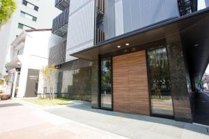an office building with a wooden garage door at Kuretake Inn Nagoya Hisayaodori in Nagoya