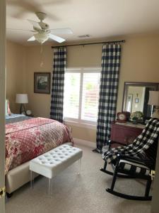 a bedroom with a bed and a chair and a window at Yahweh House in Redding