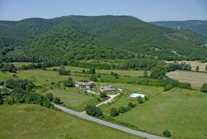 an aerial view of a house in a field with a road at Agriturismo Villa Martis in Passignano sul Trasimeno