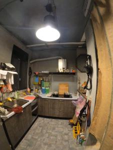 a small kitchen with a sink and a stove at 途中玉里青年旅舍On My Way Yuli Hostel in Yuli