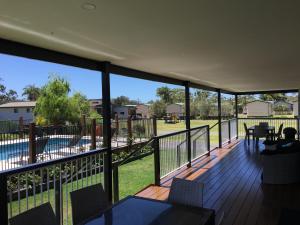 a balcony with a view of a swimming pool at Laguna lodge in Sussex Inlet