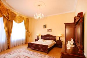 a bedroom with a bed and a chandelier at Ekaterina Hotel in Odesa