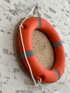 an orange life buoy hanging on a wall at Ash Villa in Al Sharqiyah