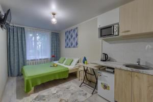 a small kitchen with a green table in a room at YourHouse микрорайон 1, дом 76 - экономичнее квартиры, уютнее гостиницы in Almaty +34 photos