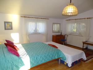 une chambre avec deux lits et une lampe et des fenêtres dans l'établissement Apartment-Vlahov, à Gornji Poloj